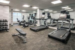 a gym with several treadmills and cardio machines at Hotel Luna in Albany