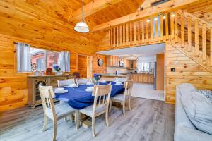 a dining room and kitchen with a table and chairs at Hot Tub and Fire Pit Lakefront Cabin in White Haven in White Haven