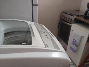 a white car parked in a kitchen with a microwave at Tranquilidade in Rio de Janeiro