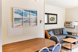 a living room with a couch and a table at Flamingo Villa @ The Reef in Chincoteague