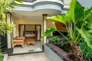 an indoor garden with plants and a house at Pondok Aruna in Ubud