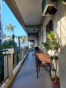 a balcony with tables and chairs on a building at MGG CASA DELA PLAYA in Boracay