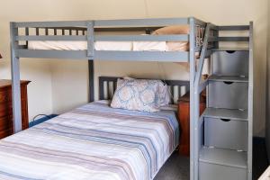 a bedroom with two bunk beds and a bed at Shipwreck Villa @ The Reef in Chincoteague