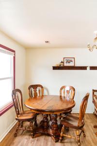 a dining room with a wooden table and chairs at Beach House @ The Reef in Chincoteague