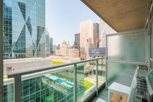 a balcony with a view of the city at RivetStays - The Yonge in Toronto