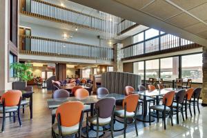 a restaurant with tables and chairs in a building at Drury Plaza Hotel San Antonio Airport in San Antonio