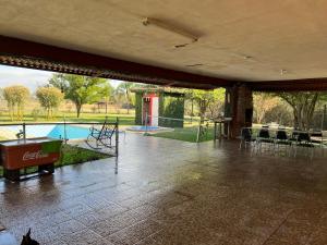 a pavilion with a pool and a table and chairs at Quinta don juanito in Monterrey