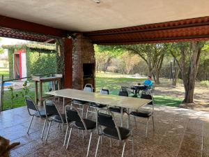 a table and chairs on a patio with a person at Quinta don juanito in Monterrey