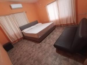 a small bedroom with a bed and a television at Quinta don juanito in Monterrey