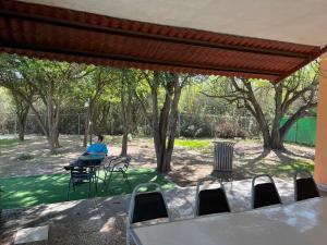 a woman sitting in a chair under a tent at Quinta don juanito in Monterrey