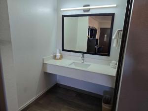 a bathroom with a sink and a mirror at Motel 6 Oklahoma City OK Frontier City in Edmond