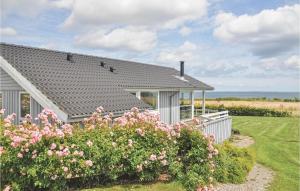 a house with pink flowers in front of it at Holiday Home Bellevue Iii in Skovby