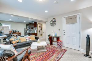 a living room with a couch and a table at Pet-Friendly Silver Spring Condo with Yard! in Silver Spring