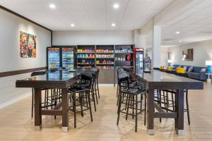 a restaurant with two tables and stools in a room at Comfort Inn & Suites Danbury-Bethel in Danbury