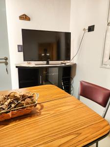 a table with a television and a basket of mushrooms on it at Departamento DORREGO, A estrenar in Guaymallen
