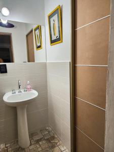 a bathroom with a sink and a mirror at Departamento DORREGO, A estrenar in Guaymallen