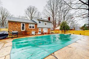 a swimming pool in front of a house at The Pool House in Charlotte
