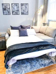 a bedroom with a large bed and a couch at 1 Bedroom Apartment in the City Centre of Nottingham - UNDER NEW MANAGEMENT in Nottingham