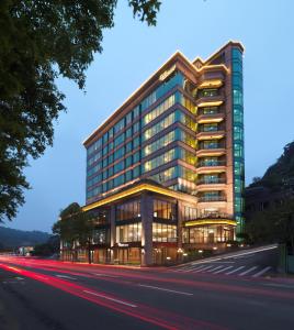 a building on a street in front of a road at Yusense Hotel in Taipei