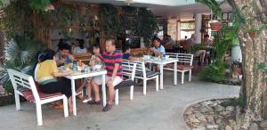 a group of people sitting at tables in a restaurant at Konklor Hotel in Kon Tum