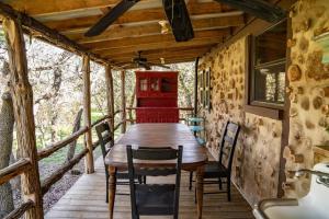 a dining room with a wooden table and chairs at A Rustic Romantic Getaway in Texas Hill Country in San Marcos