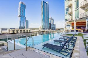 a swimming pool on the roof of a building with chairs at Downtown 1br w gym wd pool nr Capitol ATX-83 in Austin