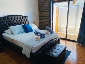 a bedroom with a large bed with towels on it at Bungalows Ballena in Uvita