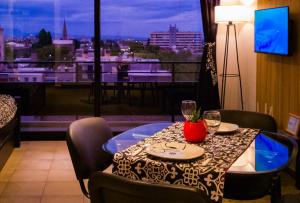 a table in a room with a view of a city at Nuevo Natania Vista Cordillera in Godoy Cruz