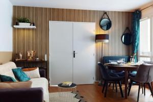 a living room with a couch and a table at Proche Disney & Paris-2 min gare in Noisy-le-Grand +26 photos