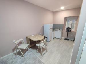 a kitchen with a table and chairs and a refrigerator at Apartman Matej in Trebinje