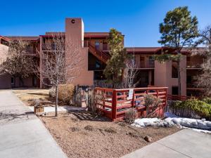 a building with a red fence in front of it at Cielo Grande 303, 2 Bedrooms, HDTV, Pet Friendly, Sleeps 6 in Santa Fe