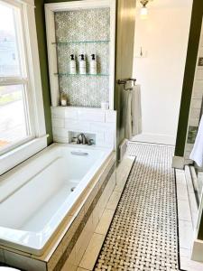 a bathroom with a bath tub with a window at The Vintage Daisy in Pocatello +9 photos