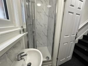 a bathroom with a sink and a glass shower at Premier Nottingham Studios - Gawthorne in Nottingham