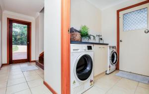 a laundry room with a washer and dryer at Damia 1 Hideaway Agnes Water in Agnes Water