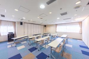 una classe con tavoli e sedie in una stanza di Court Hotel Asahikawa a Asahikawa