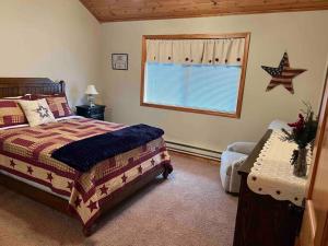 a bedroom with a large bed and a window at Cabin on the Green in Thayne