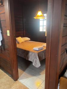 a small room with a small bed in it at Cabañas en Parque Aqua Park in Juan L. Lacaze