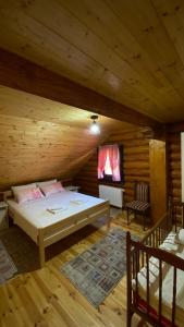 a bedroom with a bed in a log cabin at Family friendly house with a parking space Otocac, Velebit - 20654 in Otočac
