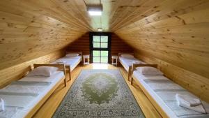 a room with four beds in a wooden room at Family friendly house with a parking space Otocac, Velebit - 20654 in Otočac