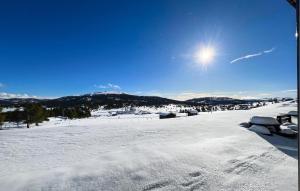 a snow covered field with the sun in the sky at Pet Friendly Apartment In Kvam With Wi-fi in Kvam