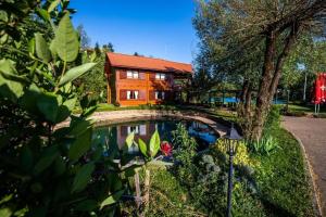a house with a pond in front of a house at Apartments with a parking space Donji Zvecaj, Karlovac - 22080 in Duga Resa