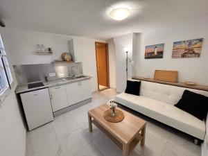 a living room with a couch and a table at CASA ELEO in Arrecife