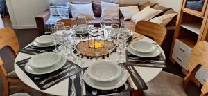 a dining room table with glasses and plates on it at Baireshistorico in Buenos Aires