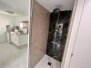 a shower with a glass door in a bathroom at CASA ELEO in Arrecife