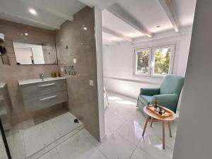 a bathroom with a blue chair and a table and a sink at CASA ELEO in Arrecife +27 photos