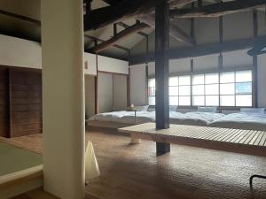 Llit o llits en una habitació de 伊風ifu貸切一棟宿
