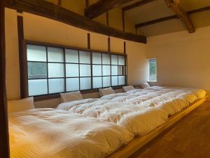 Llit o llits en una habitació de 伊風ifu貸切一棟宿
