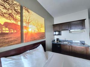 a hotel room with a bed and a sink at Days Inn by Wyndham Kemah in Kemah