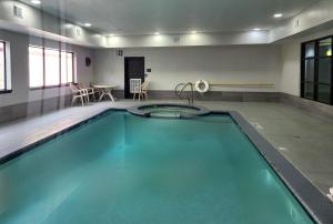 a swimming pool in a room with a table and chairs at Days Inn by Wyndham Kemah in Kemah