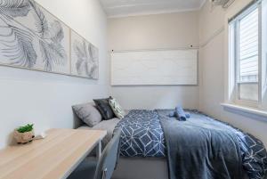 a bedroom with a bed and a couch in it at Boutique Private Room near Sydney Airport - Guesthouse in Sydney